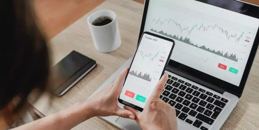 Forex trader using crypto exchange mobile phone app for investment and stock market analysis