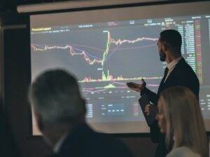 the-man-standing-near-the-screen-on-the-business-m-2023-11-27-04-56-55-utc-min.jpg